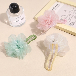 Elegant organza flower hair claws in pink, green and yellow for stylish hair styling