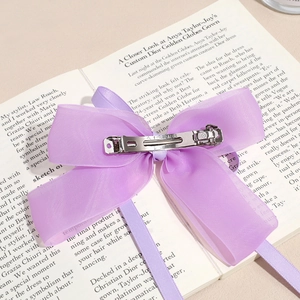 Elegant purple double-layer bow hair clip with organza and satin on vintage book