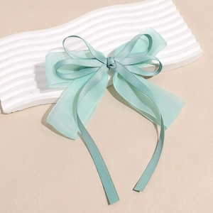Detail of mint green double-layer bow hair clip with organza and satin ribbon