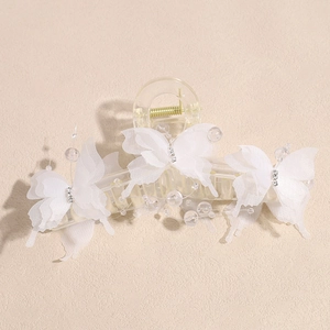 Detail of white 3D butterfly hair claw clip with rhinestones and transparent beads