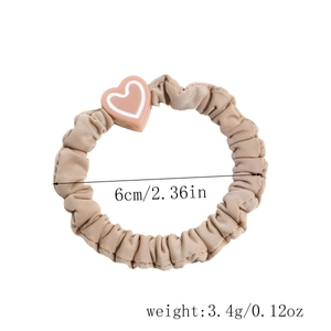 Detail showing khaki scrunchie with pink heart pendant and 6cm diameter size guide