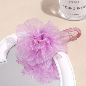Detailed view of the purple organza flower hair clip with elegant sheer layered petals