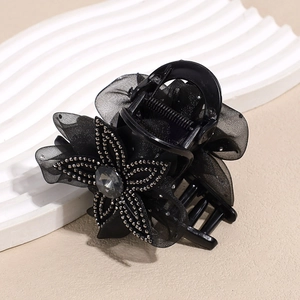 Detailed view of the mesh flower hair claw clip with rhinestones and center gemstone