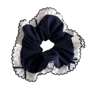 Navy blue oversized scrunchie with white scalloped lace edges and mini ribbon bows