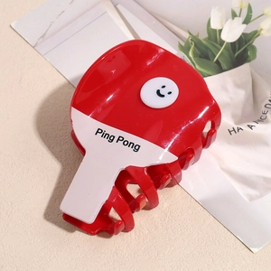 Dettaglio molletta per capelli a forma di racchetta da ping pong rossa con smiley