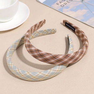 Elegant plaid pattern headband set with handmade label on a stylish marble background