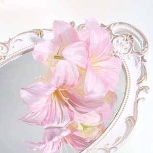 Detailed close-up of a pink 3D lily flower hair claw clip on a vintage mirror surface