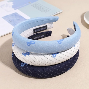 Three-piece set of navy blue and white striped knotted headbands with bow patterns