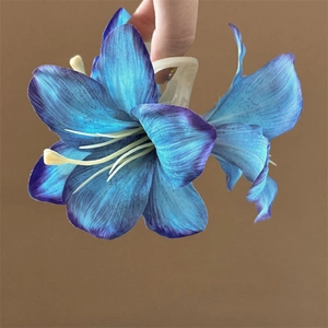 Detailed macro shot of a blue and purple lily hair claw clip with silk fabric texture