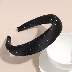 Detailed view of black satin headband with sparkling silver rhinestones and thick sponge padding