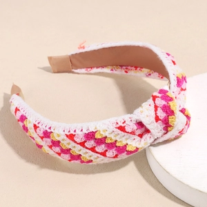 Detailed view of the multi-colored knitted floral headband with soft yarn texture and knot