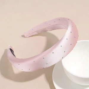 Detail of pink satin headband with sparkling rhinestones and thick sponge design
