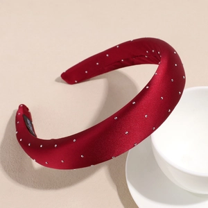 Close-up of wine red satin headband with sparkling silver rhinestone embellishments