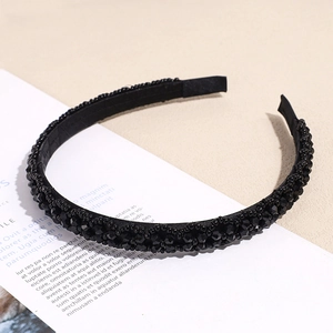 Elegant black beaded headband featuring faceted crystal beads on a minimalist fabric base