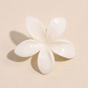 Detailed macro view of the cream white flower hair claw clip with marble texture