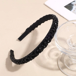 Elegant black beaded headband with crystals on beige background for women styling