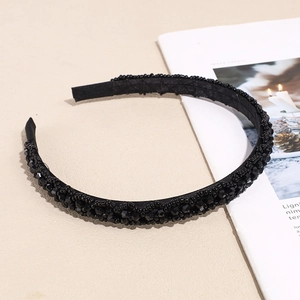 Elegant black crystal beaded headband with shimmering multi-faceted beads on fabric