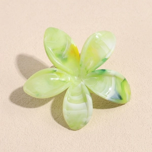 Detailed top view of the green gradient flower hair claw clip with acetate marble texture
