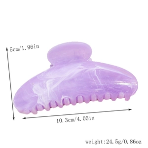 Detail showing marble textured hair claw clip dimensions of 10.3cm length and 5cm height