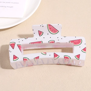 Close-up of a square cream hair claw clip with vibrant red watermelon pattern print