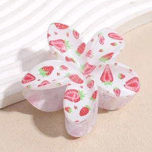 Close-up of white flower hair claw clip with red strawberry prints and metal spring