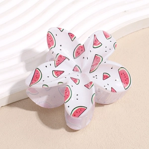 Detailed macro view of a floral hair claw clip featuring a refreshing summer watermelon pattern