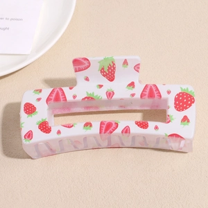 Detailed view of cream square hair claw clip with red strawberry floral patterns