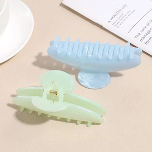 Blue and mint green marble pattern acetate hair claws with gold-tone metal spring