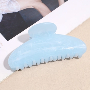 Detail shot of blue marble pattern acetate hair claw clip with strong metal spring