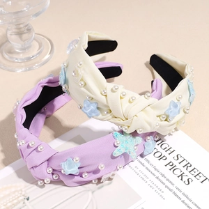 Fashionable knot headband with starfish charms and white pearls in yellow and lavender colors