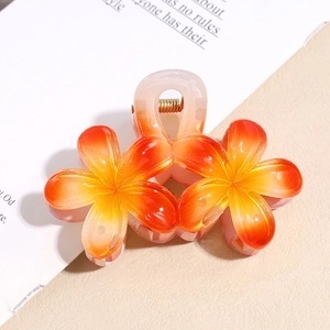 Dettaglio molletta per capelli a forma di fiore arancione sfumato con molla dorata