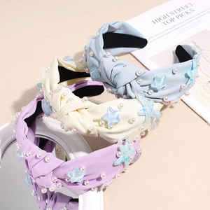 Three-piece set of knotted starfish headbands with pearls and pleated fabric in blue and yellow