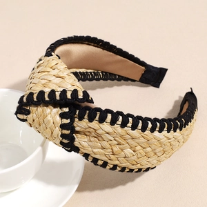 Detail of bohemian knotted straw headband with black crochet trim and woven texture