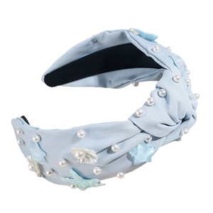 Fashionable light blue knotted headband with sea stars, pearls, and shells decorations