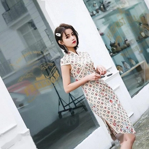 Vue latérale d'une robe qipao fleurie avec fente latérale et col montant en décor urbain