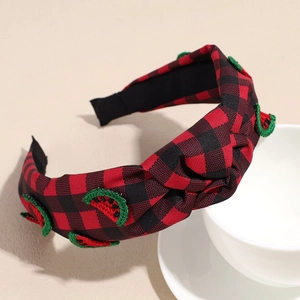 Detail showing red buffalo plaid knotted headband with embroidered watermelon patches
