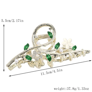 Détail d'une grande pince à cheveux dorée avec feuilles d'émail vert et dimensions 11,5x5,5cm