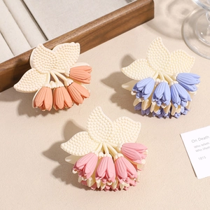 Three tulip-shaped flower hair claws in pink blue and orange with matte resin finish