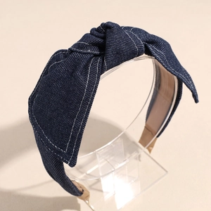Detail of dark blue denim headband with white contrast stitching and center knot