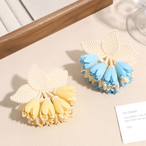 Elegant floral claw clips in blue and yellow tulip designs for women's hair styling
