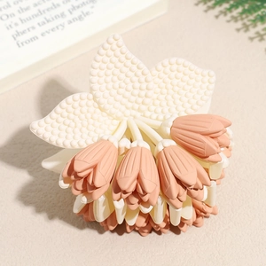 Detailed close-up of matte tulip flower claw clip with cream white and pink petals