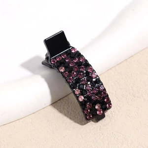 Detail of elegant black hair clip with sparkling pink rhinestones and black beads