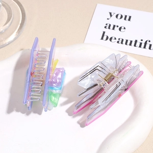 Creative book-shaped hair claws in shell texture and butterfly patterns on white tray