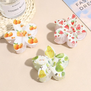 Three watercolor fruit print flower hair claws featuring orange strawberry and pear patterns