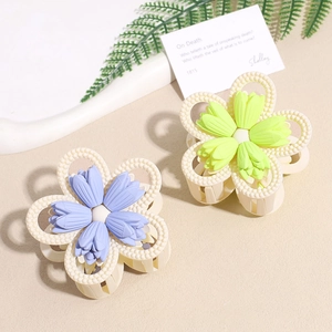 Two matte floral hair claws in lavender and lime green with frosted texture finish