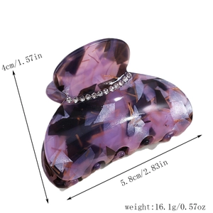 Detail view of purple marble acetate hair claw with rhinestones and 5.8cm size dimensions