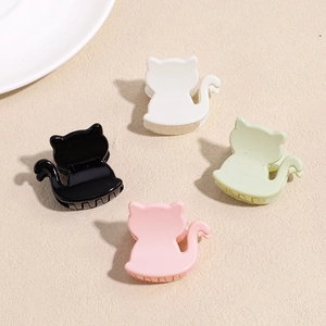Set of four colorful cat-shaped hair claws in black, white, pink and green acrylic