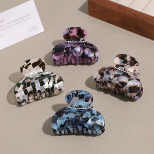 Elegant 4-piece set of acetate hair claws with rhinestones in vintage colors