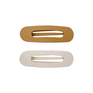 Fermagli ovali opachi in caramello e crema con un design minimalista traforato