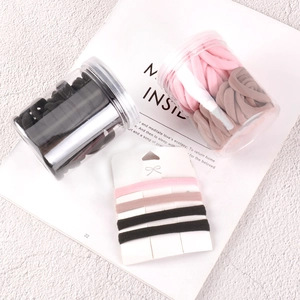 Seamless elastic hair ties set in black, pink, and brown with jars and card display